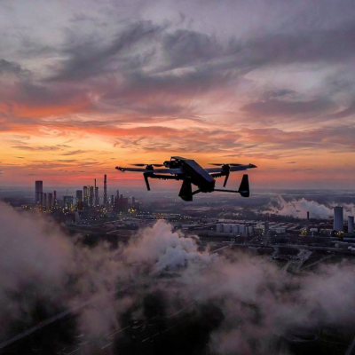Ukrainian long-range drone flying over industrial skyline at dusk during Russia Ukraine war 2026