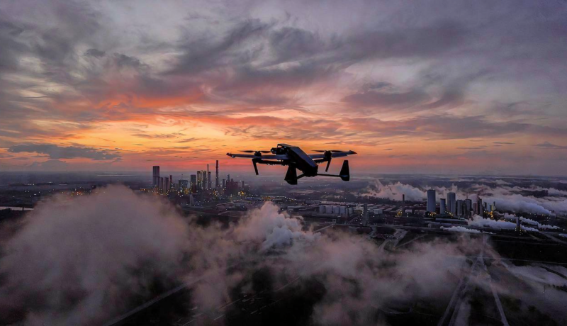 Ukrainian long-range drone flying over industrial skyline at dusk during Russia Ukraine war 2026